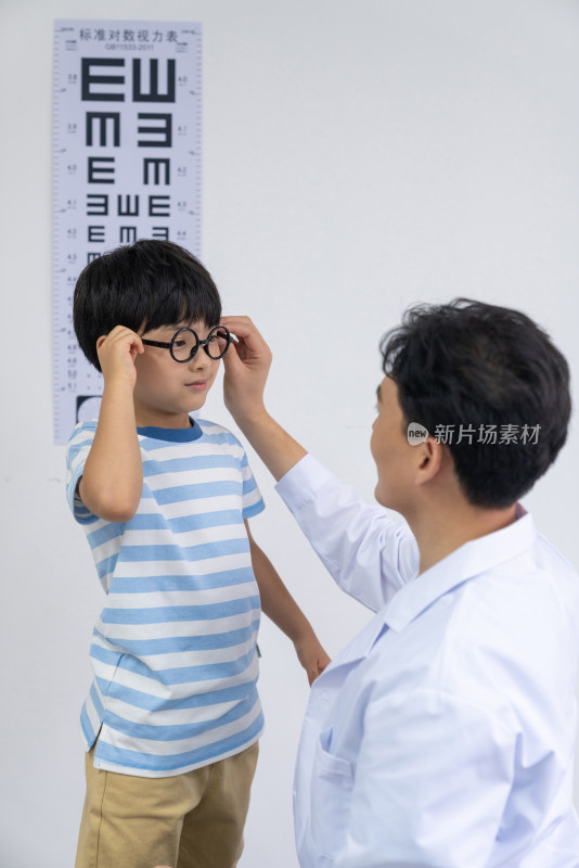 眼科大夫给小男孩检查眼睛