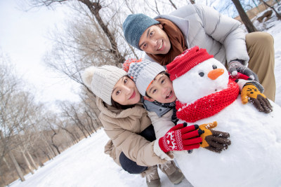 一家三口在雪地里堆雪人