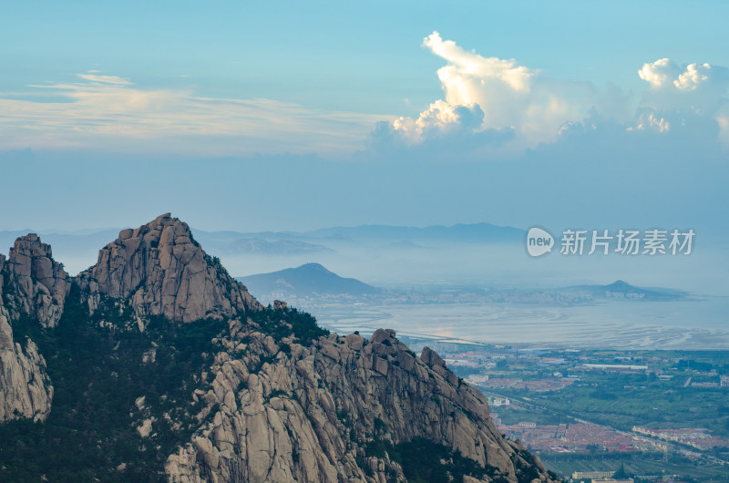 中国青岛崂山仰口景区，远眺云彩云下的村落