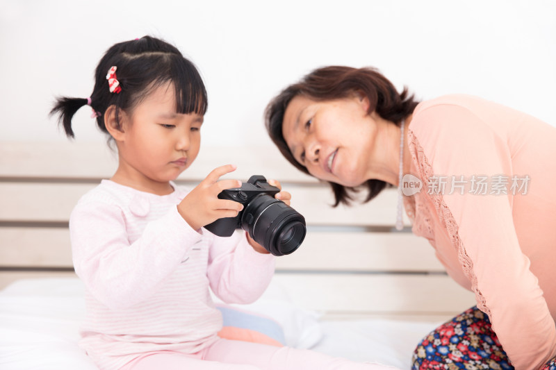 奶奶和孙女一起翻看相机里的照片