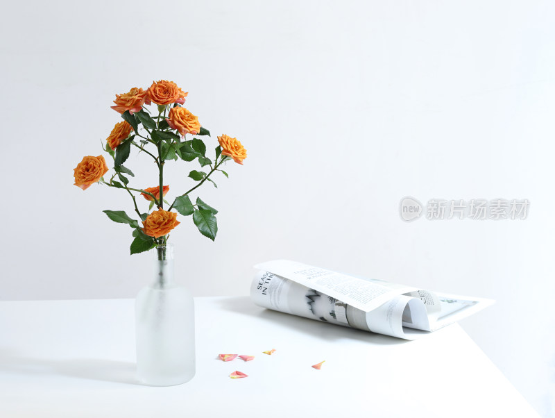 白色桌面上的书籍和一束玫瑰花