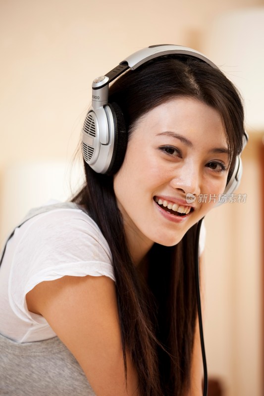 年轻女人戴着耳机听音乐