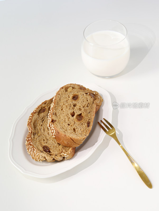 白色桌面上的早餐粗粮面包和牛奶
