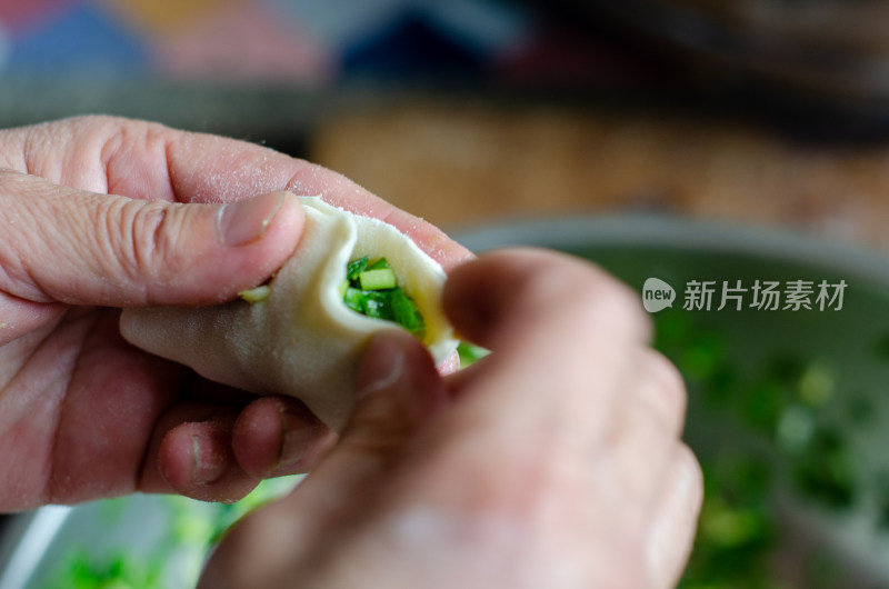 正在包韭菜鸡蛋饺子的女人的手特写