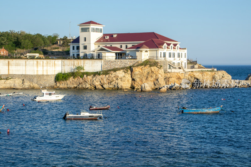 辽宁大连海岸边建筑与海上小船