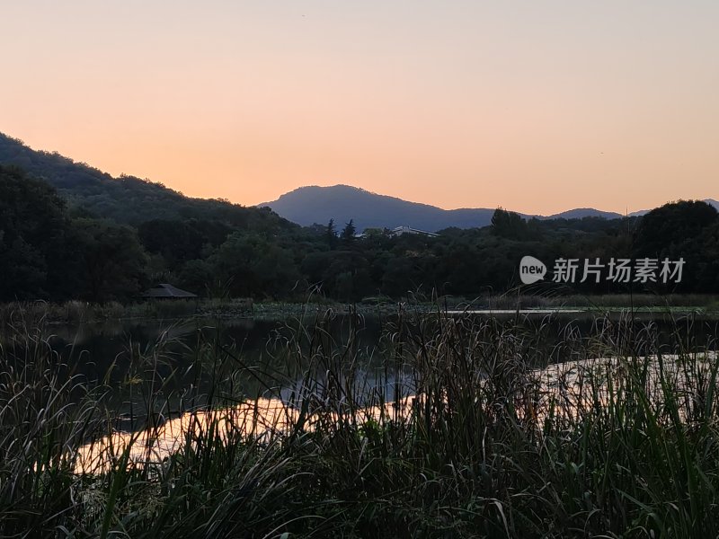 湖边黄昏美景，山林倒映在水中