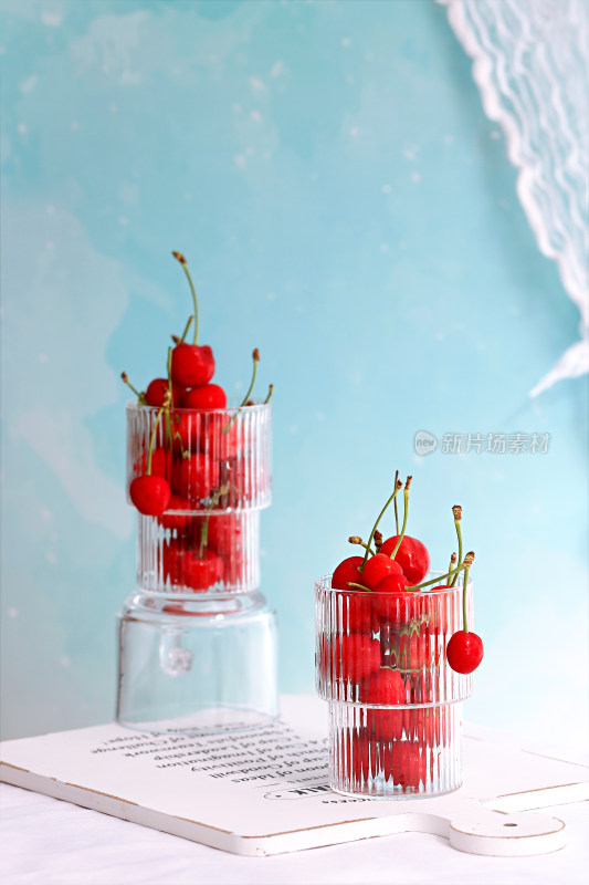 桌面上的两杯新鲜水果樱桃