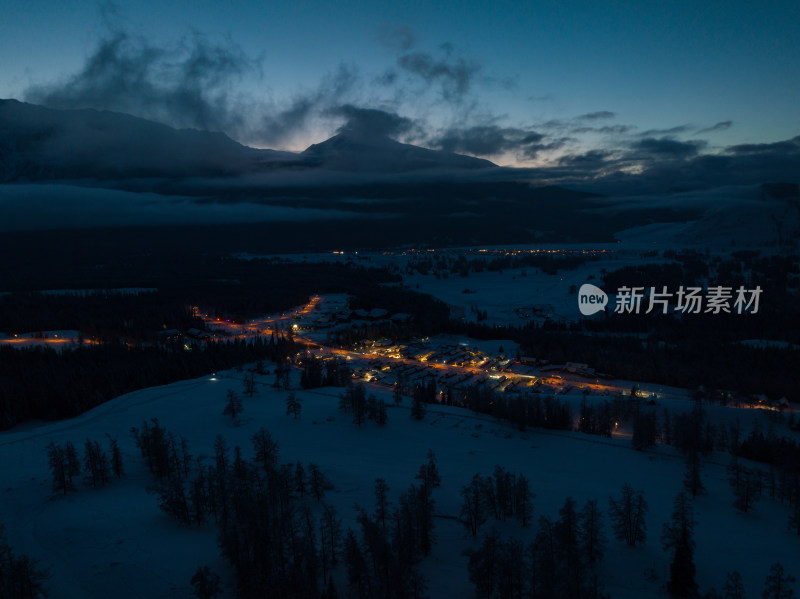 航拍冬季雪后的新疆喀纳斯乡村夜景