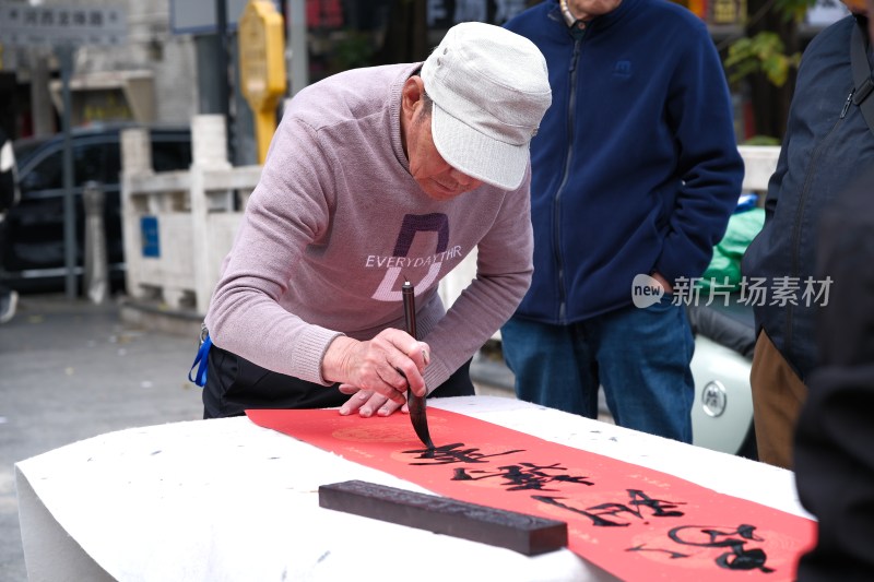 老人户外书写毛笔字场景