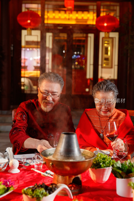 春节东方老年夫妇在中式庭院内聚餐