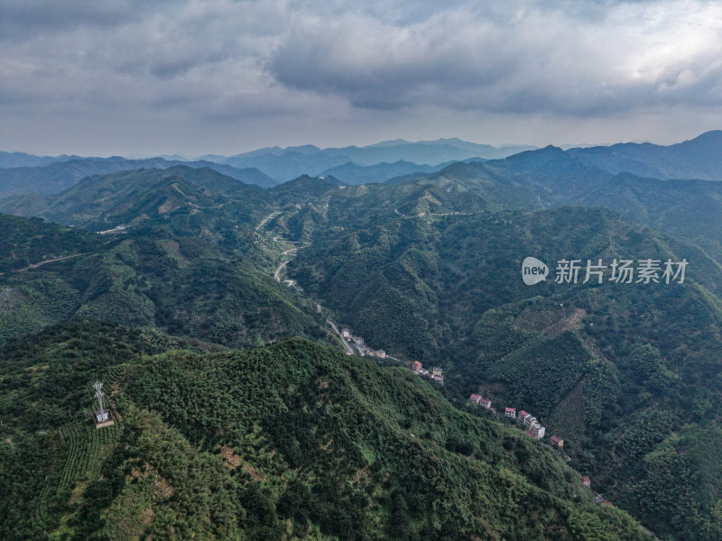 航拍山间公路及山下村庄的自然风光