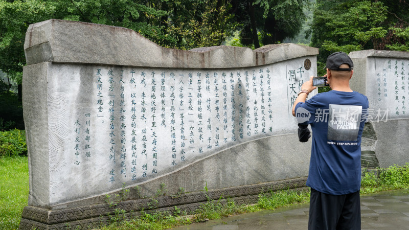 游客们冒雨游览成都都江堰景区