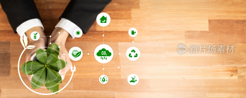 商务人士手捧绿植与环保图标