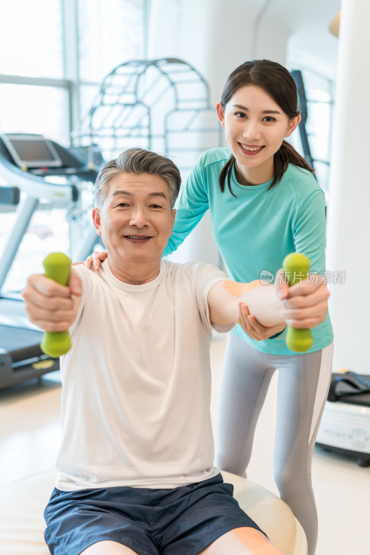 老年男子在私教的指导下健身