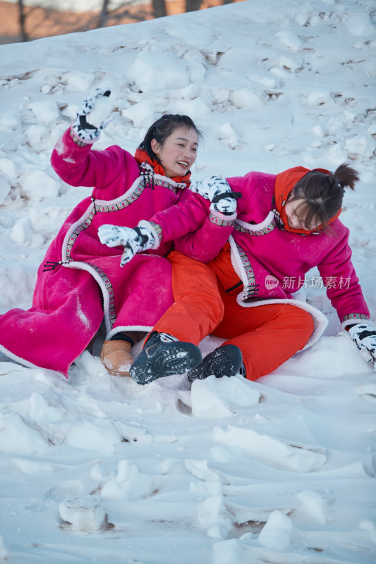 在雪地上打闹嬉戏开心玩耍的闺蜜少女