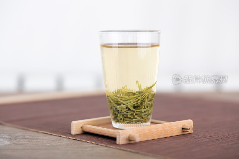 一小杯信阳毛尖绿茶在茶托上