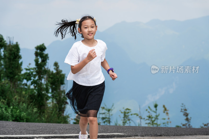 晴朗的夏天午后走在盘山公路上的东方女孩