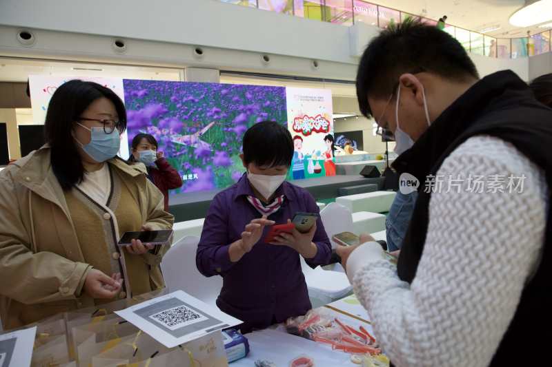 商场内人们扫码互动场景