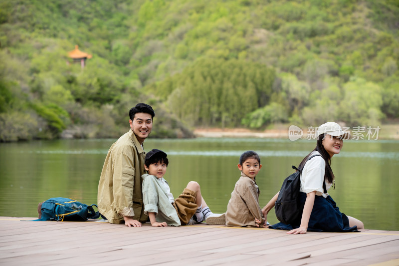 快乐家庭坐在湖边看风景