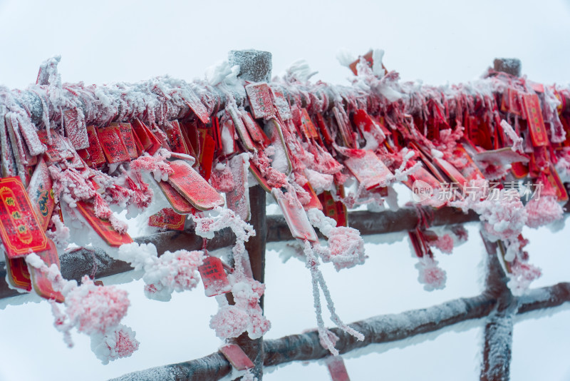 寒冷冬季大雪中悬挂的红色祈福牌