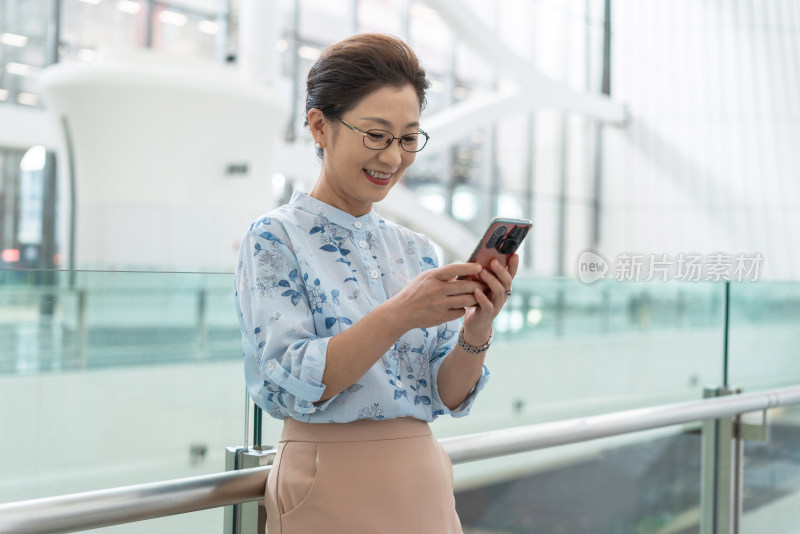 老年女人在机场使用手机