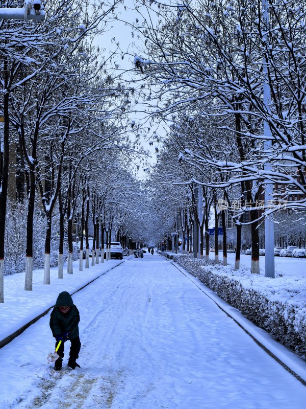 雪后街道，一个玩雪的小孩