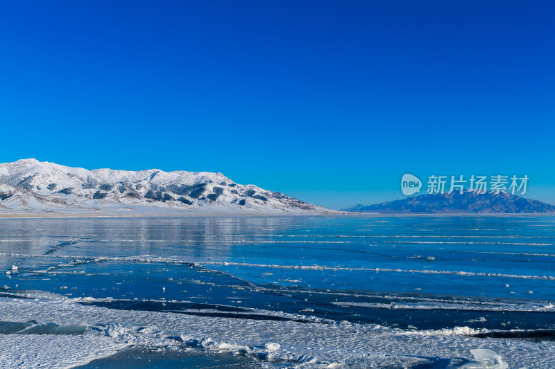 新疆冬季赛里木湖雪景雪山冰湖蓝冰日照金山