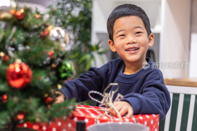 一个小男孩搂着圣诞圣诞礼盒
