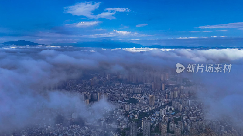 云海下的城市高楼四川乐山航拍图