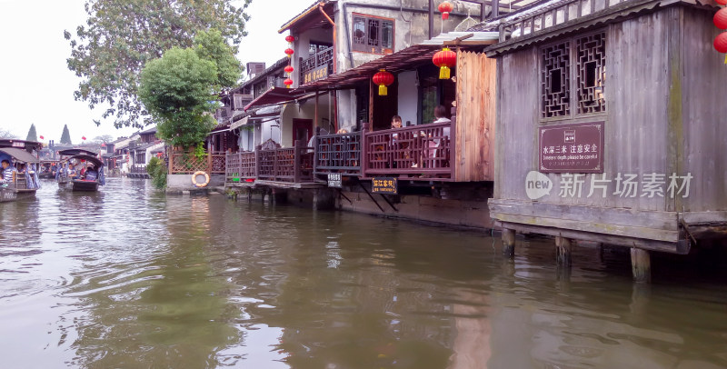 江南水乡沿河民居与游船景象