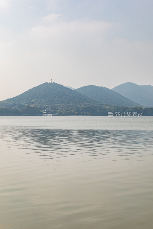 徐州平静湖水与远处山峦景观