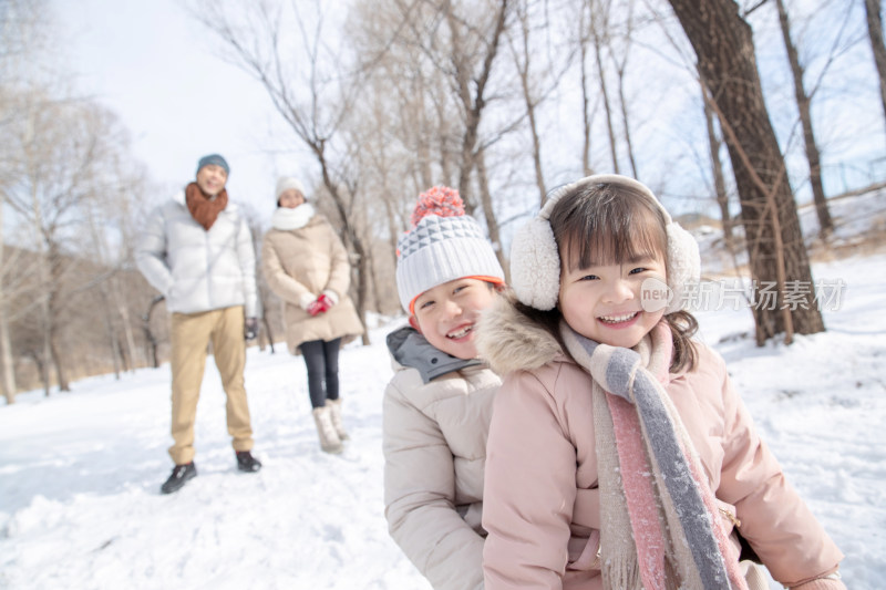 欢乐家庭在雪地上玩雪橇