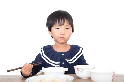 可爱的中国小女孩正在吃饺子