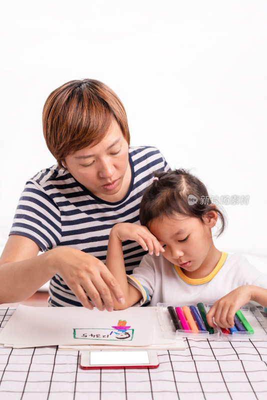 年轻的中国母亲和孩子一起画画