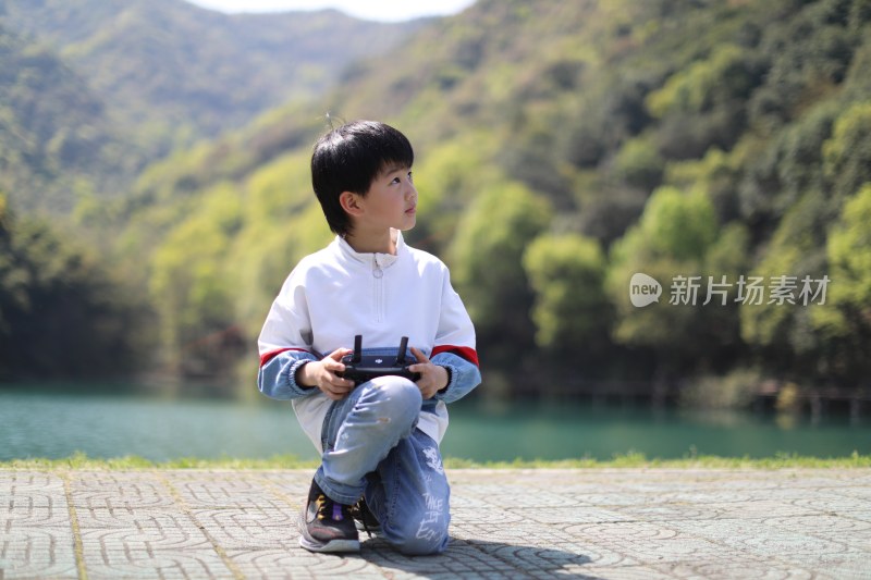 在湖边玩的中国小男孩