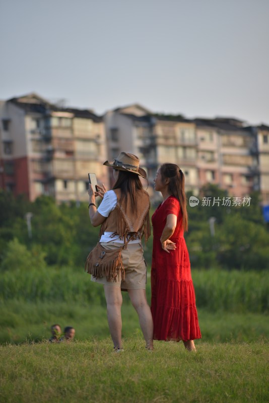 两位女性户外草地拍照场景