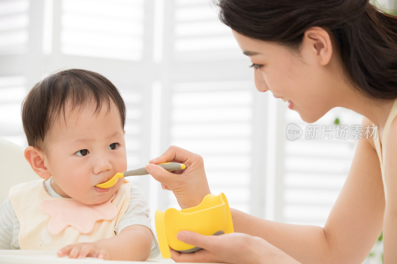年轻妈妈喂宝宝吃饭