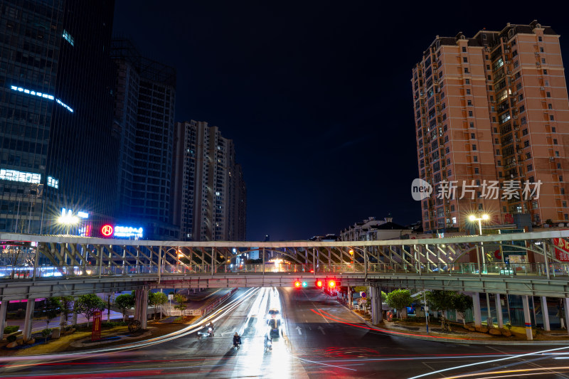 夜晚城市过街天桥下的车流光轨