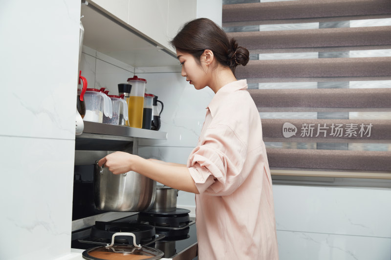 在厨房下厨的年轻亚洲女性